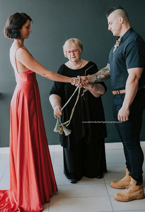 Jennifer Cram Marriage Celebrant carrying
                    out a Handfasting