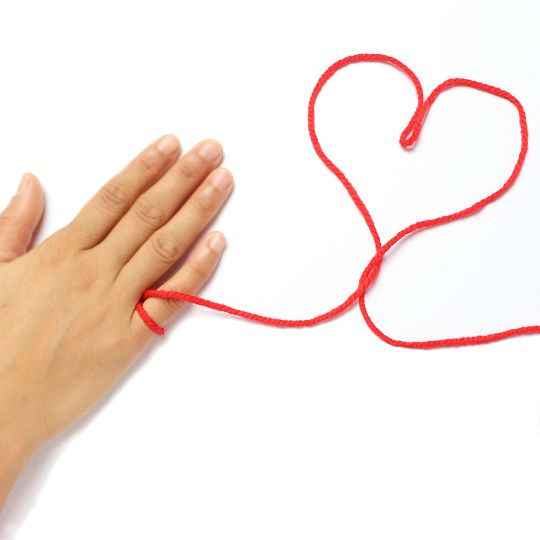 Red
                        string tied to a pinky finger and shaped into a
                        heart