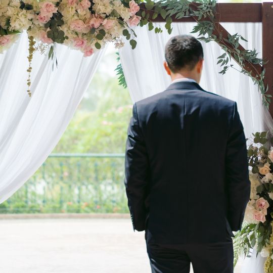 Groom turning his
                        face away from the bride as she makes her
                        entrance