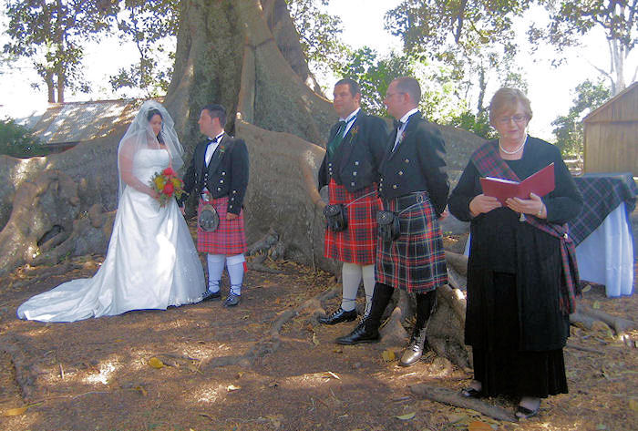 Jennifer
                            Cram officiating a Scottish wedding wearing
                            a McDonald tartan sash