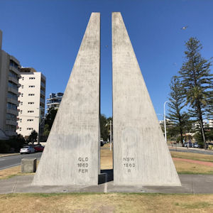 The Centernary of
                      Federation Marker for the border between
                      Queensland and New South Wales. Grey concrete
                      triangles reaching up into the sky on either side
                      of a painted line