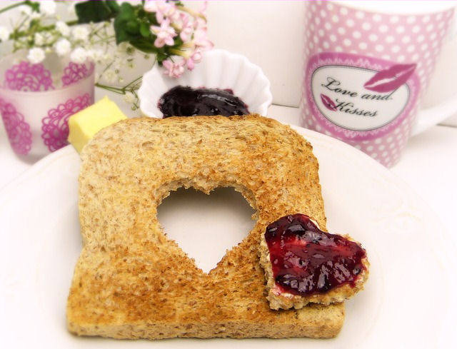 Breakfast wedding toast with heart cut out,
                      jam, and love and kisses wedding favor