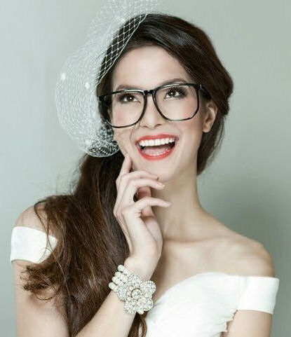Laughing bride wearing glasses and bright
                      lipstick