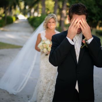 Groom
                          covering his eyes with his hands as bride
                          approaches from behind