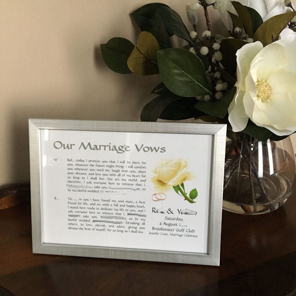 Wedding Vows in Silver Frame next to vase of
                      white magnolia flowers