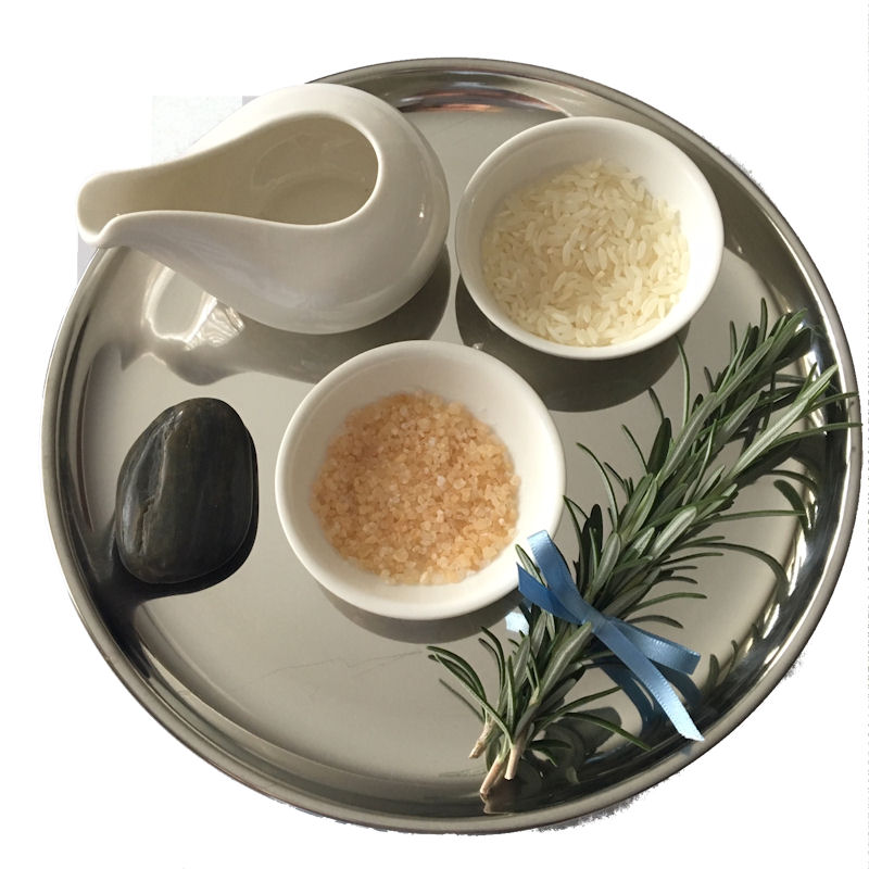 Fruits of the Earth Ritual. Silver Tray
                      containing white water jug, black pebble, white
                      dishes containing rice and salt, and a sprig of
                      rosemary tied with a blue ribbon