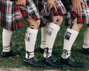 Groomsmen
                            displaying the sgian dubh in their hose.
                            Photo by Figtree Pictures