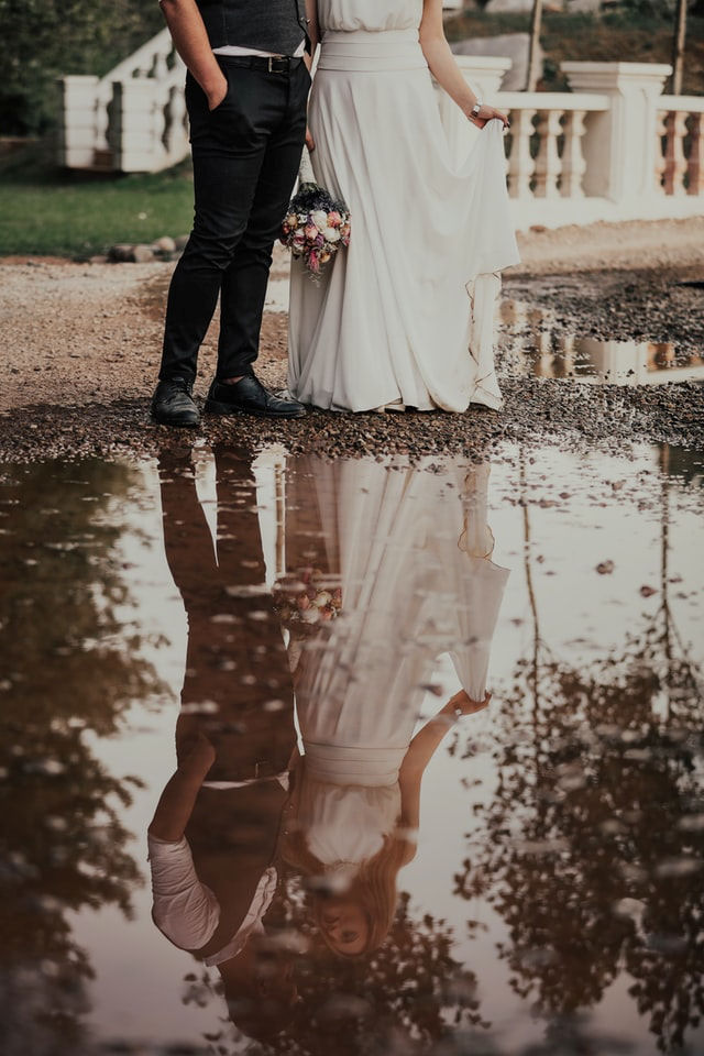 Marrying couple
                      reflected in water
