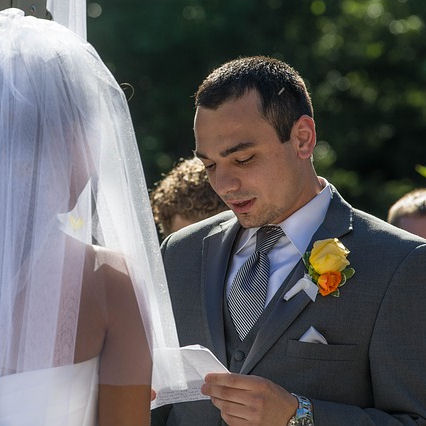 Groom reading personal
                        vows