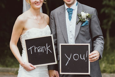 Wedding Couple
                      with Thank You Signs