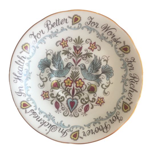 Bone China saucer that has the words
                              For Better For Worse In Sickness In Health
                              round the rim and an illustration of two
                              blue birds in the centre together with
                              stylised floral elements