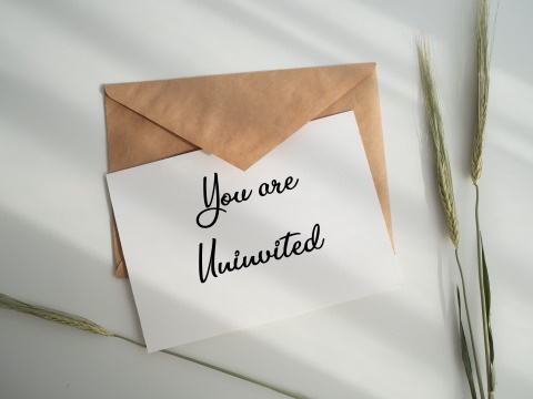 Envelope and card
                      reading You are un-invited