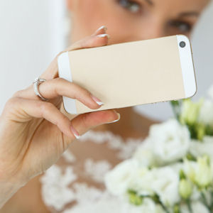 Bride holding up smart phone