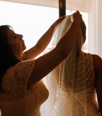 Mother of the Bride pinning the veil on