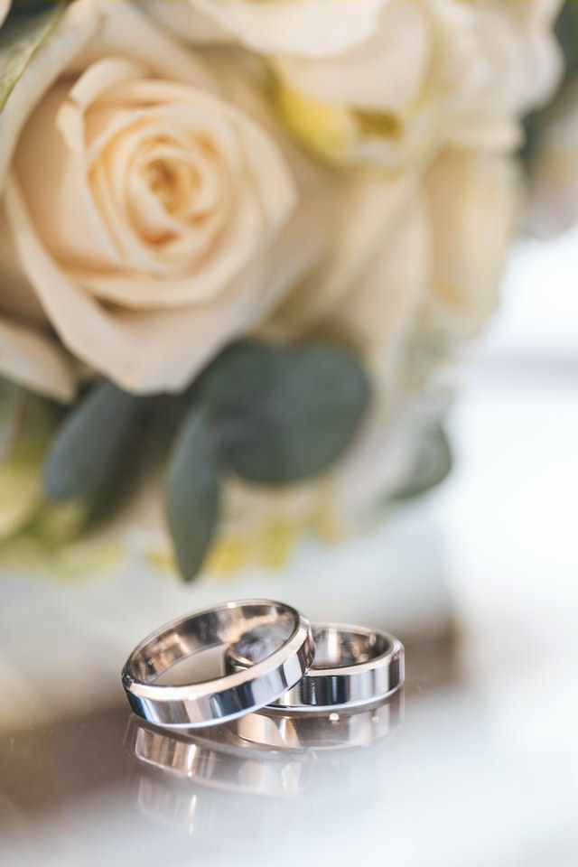 Silver wedding rings with apricot roses