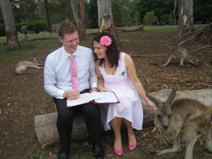 Signing the register surrounded by
                    kangaroos