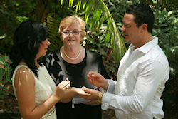 Aoife and Nathaniel
                    exchange rings in their Warm and Wonderful Weekday
                    Wedding at Mt Coot-tha Botanic Gardens